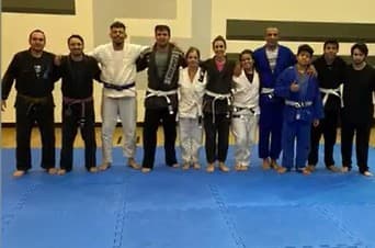Equipe de jiu-jitsu do professor José Alfredo reunida no tatame, de kimono